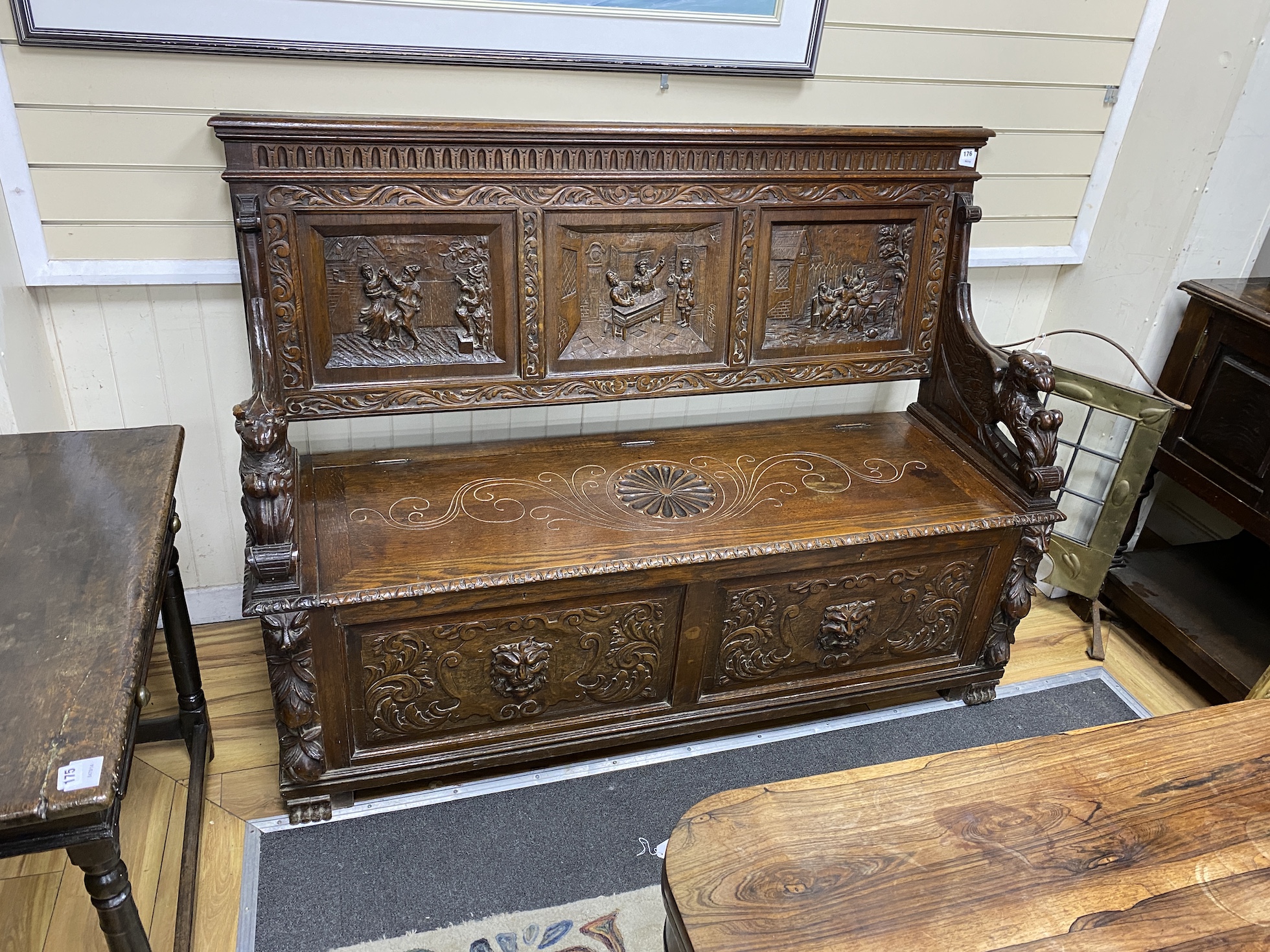 A 19th century Flemish carved oak box seat settle, width 161cm, depth 60cm, height 117cm